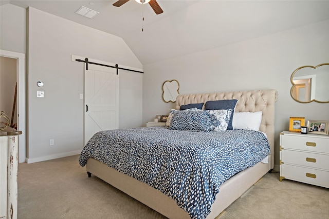 bedroom featuring ceiling fan, light colored carpet, a barn door, and vaulted ceiling