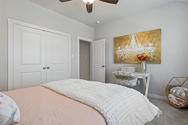 carpeted bedroom with ceiling fan and a closet