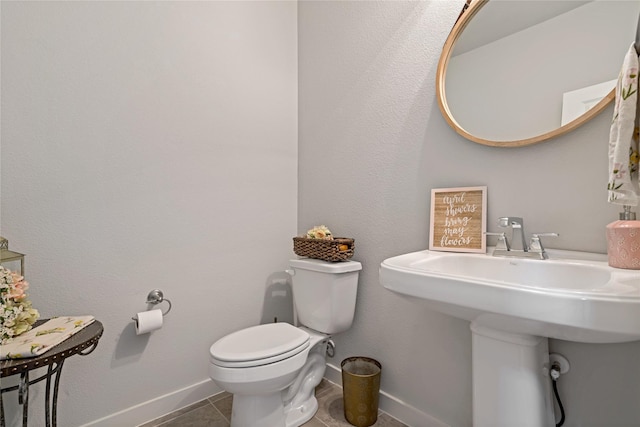 bathroom featuring tile patterned floors and toilet