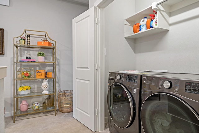 laundry room with washer and dryer and light carpet