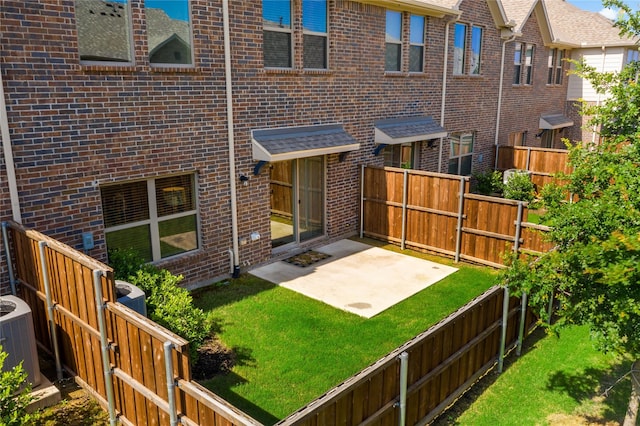 back of property with a patio, central AC unit, and a lawn