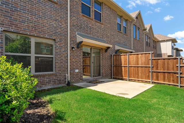 back of property with a patio area and a lawn