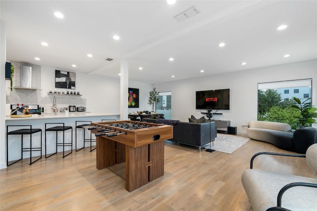 recreation room with light hardwood / wood-style flooring