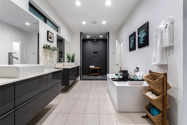 bathroom featuring vanity and separate shower and tub