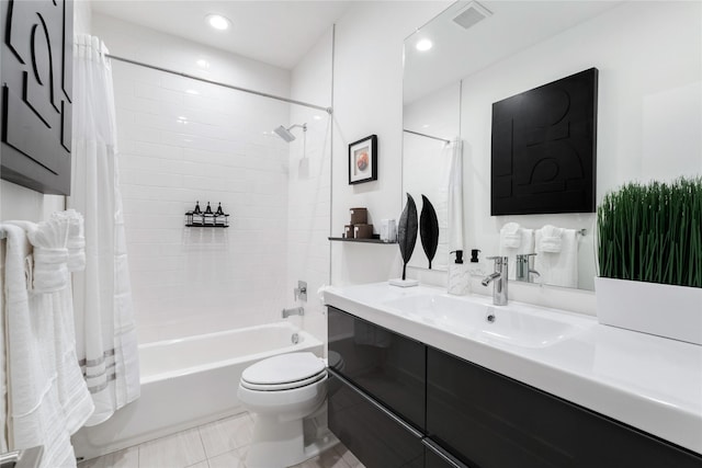 full bathroom featuring tile patterned floors, shower / bath combo with shower curtain, vanity, and toilet