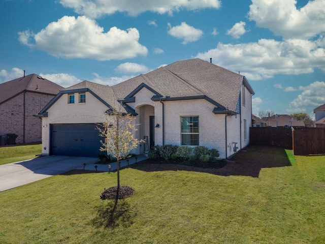 french country style house featuring a garage, brick siding, concrete driveway, and a front lawn