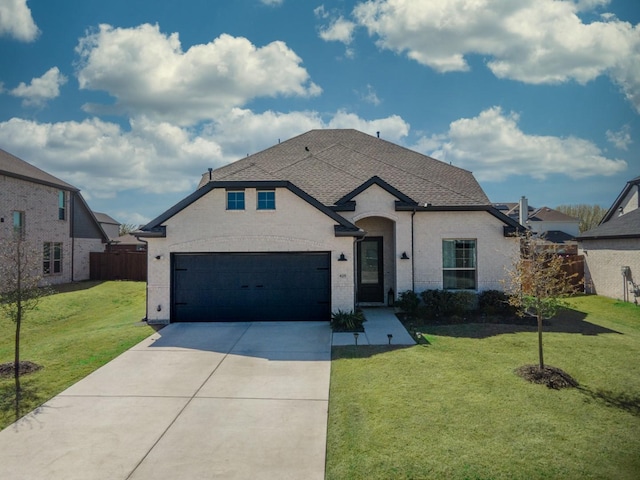 view of front of home featuring a front yard and a garage