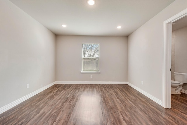 spare room featuring dark hardwood / wood-style floors