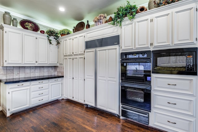 kitchen featuring tasteful backsplash, white cabinetry, dark wood-type flooring, and black appliances