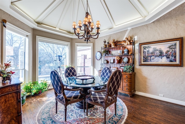 dining room with a notable chandelier, dark hardwood / wood-style floors, a healthy amount of sunlight, and crown molding