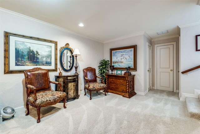 sitting room with crown molding and light colored carpet