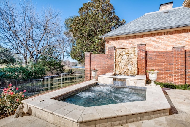 view of pool with an in ground hot tub