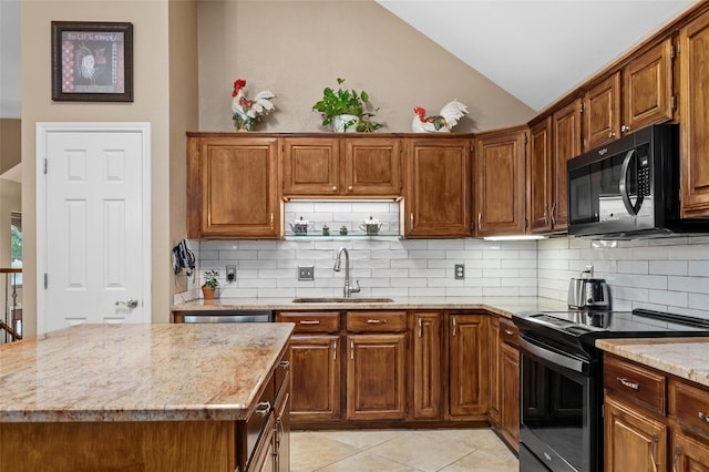 kitchen featuring backsplash, light stone counters, sink, and appliances with stainless steel finishes