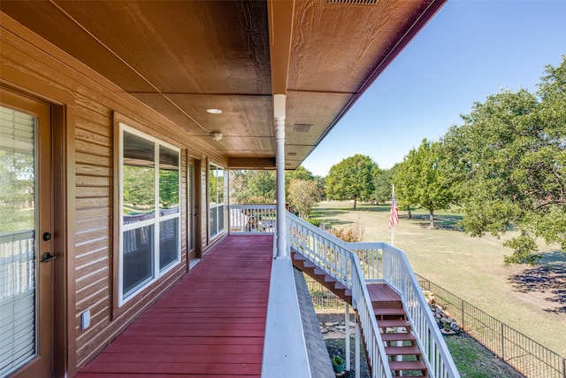 deck with covered porch and a yard