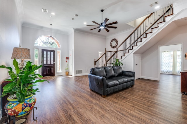 foyer with ceiling fan, dark hardwood / wood-style flooring, and ornamental molding