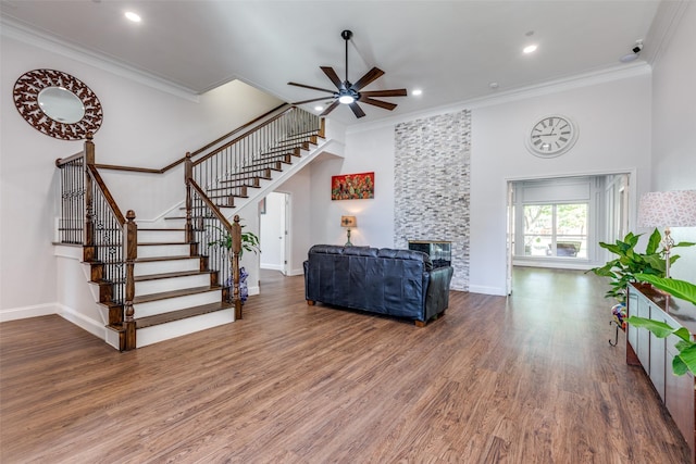 living room with ceiling fan, dark hardwood / wood-style flooring, and ornamental molding