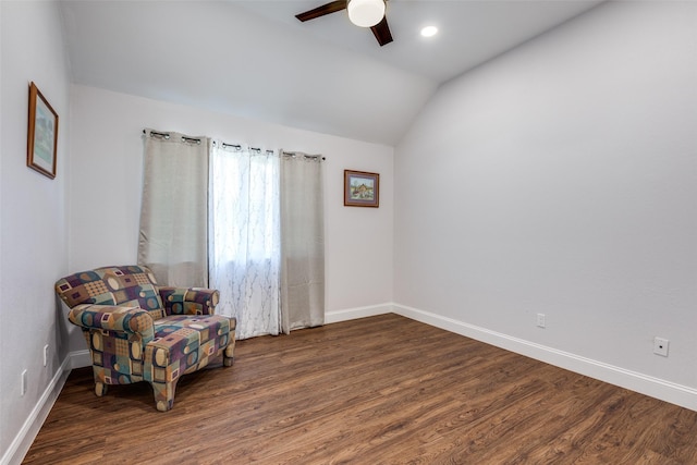 living area featuring ceiling fan, dark hardwood / wood-style floors, and vaulted ceiling