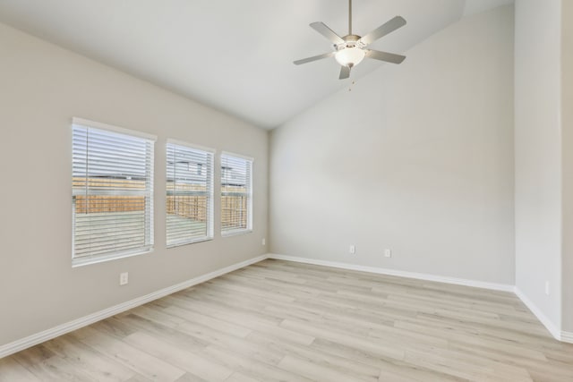 empty room with ceiling fan, light hardwood / wood-style floors, and vaulted ceiling