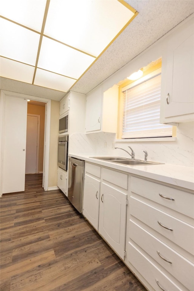 kitchen featuring white cabinetry, sink, dark hardwood / wood-style flooring, and stainless steel appliances