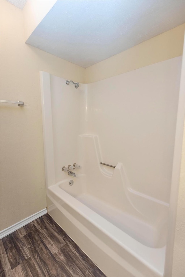 bathroom featuring wood-type flooring and shower / bath combination