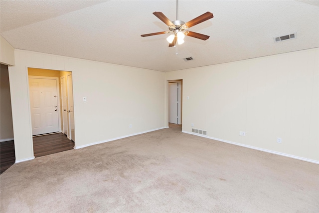 unfurnished room with ceiling fan, carpet floors, and a textured ceiling