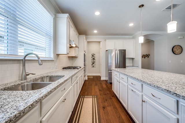 kitchen with white cabinetry, stainless steel appliances, sink, and hanging light fixtures