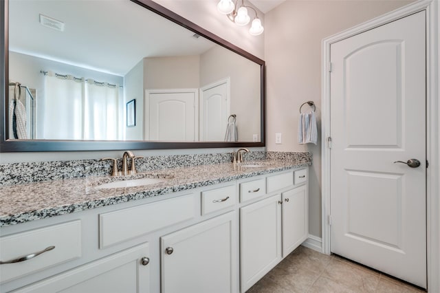 bathroom with vanity and tile patterned floors