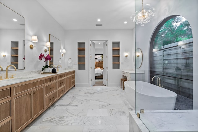 bathroom featuring built in shelves, vanity, a tub to relax in, and an inviting chandelier