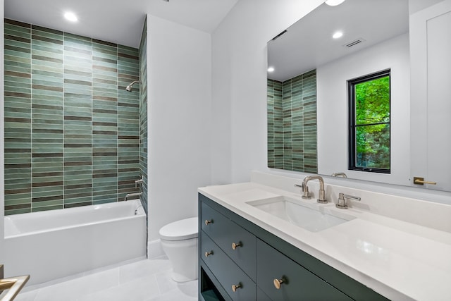 full bathroom featuring toilet, vanity, tile patterned floors, and tiled shower / bath combo