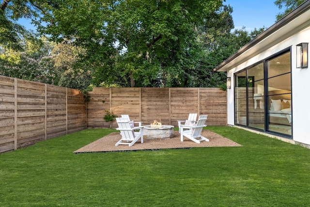 view of yard with an outdoor fire pit