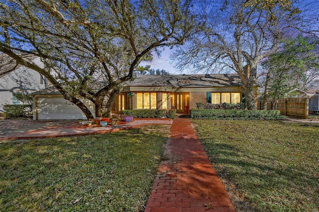 view of front facade featuring a garage and a front lawn