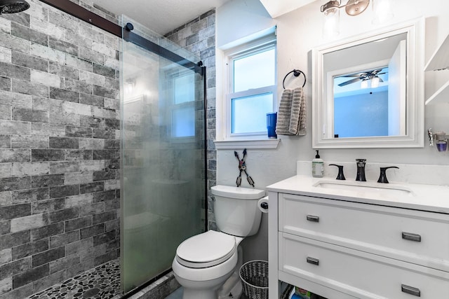 bathroom featuring vanity, ceiling fan, toilet, and walk in shower