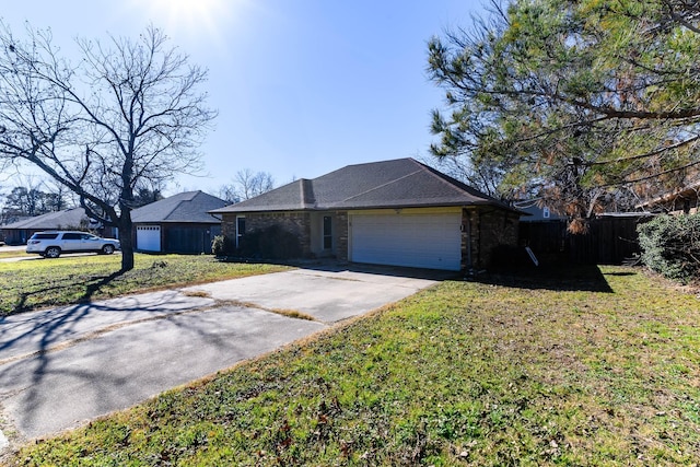 ranch-style house featuring a garage and a front lawn