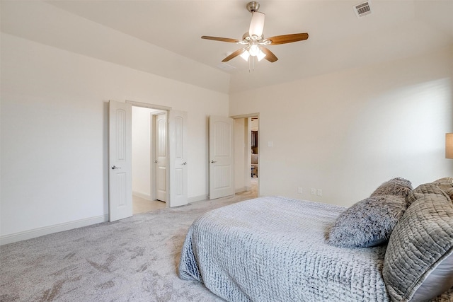 carpeted bedroom with vaulted ceiling and ceiling fan