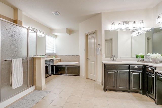 bathroom featuring plus walk in shower, tile patterned floors, and vanity