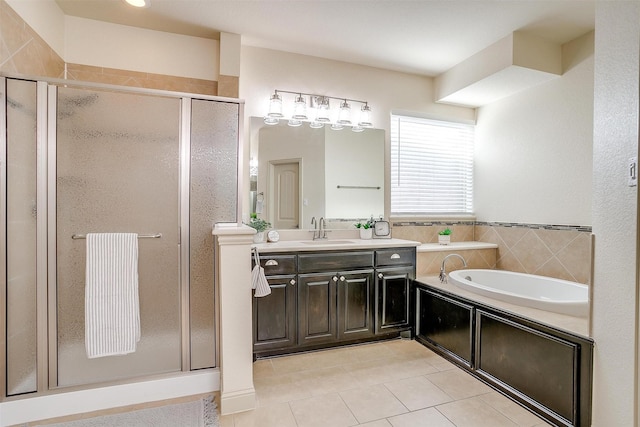 bathroom with tile patterned floors, vanity, and independent shower and bath