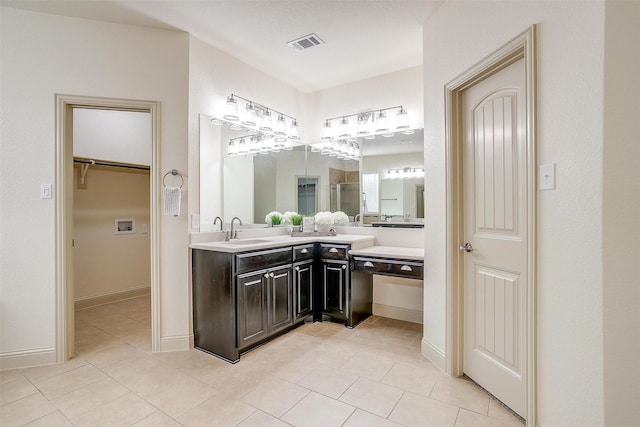 bathroom with vanity, a shower with door, and tile patterned floors