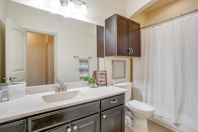 bathroom with tile patterned flooring, vanity, and toilet