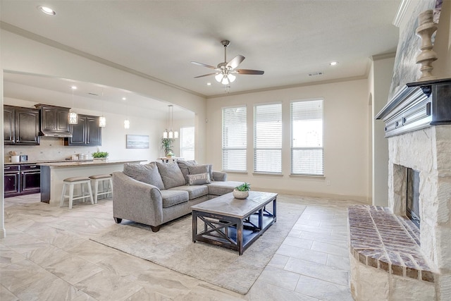 living room featuring ornamental molding and ceiling fan