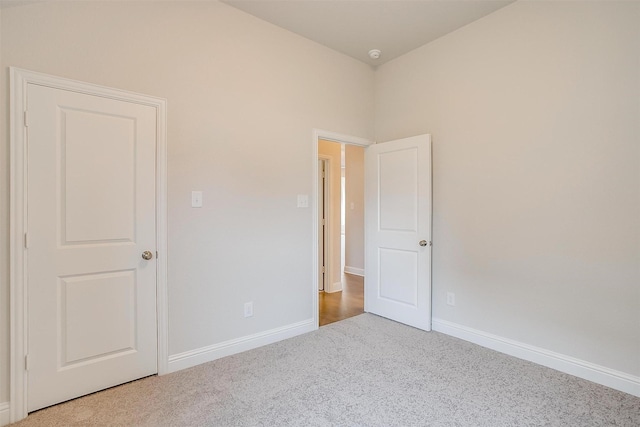 unfurnished bedroom with light colored carpet