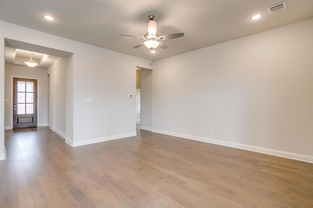 empty room with ceiling fan and hardwood / wood-style floors