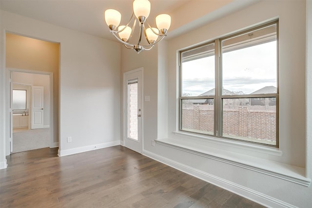 interior space with a notable chandelier and hardwood / wood-style floors