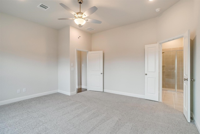 unfurnished bedroom featuring light carpet, ceiling fan, and a towering ceiling