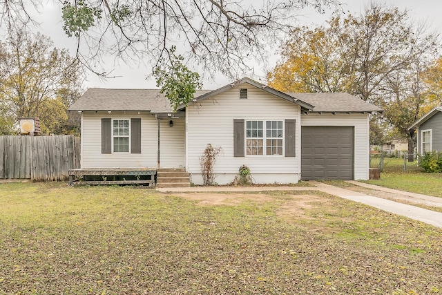 single story home featuring a garage and a front lawn