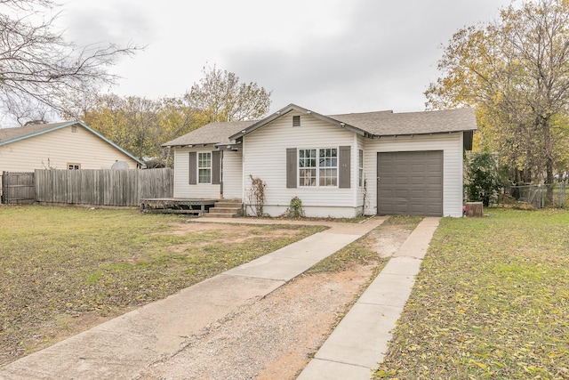 view of front of home with a garage and a front lawn