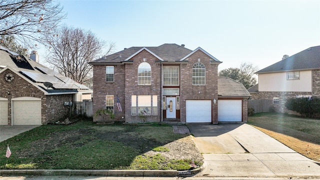 front facade with a garage and a front yard