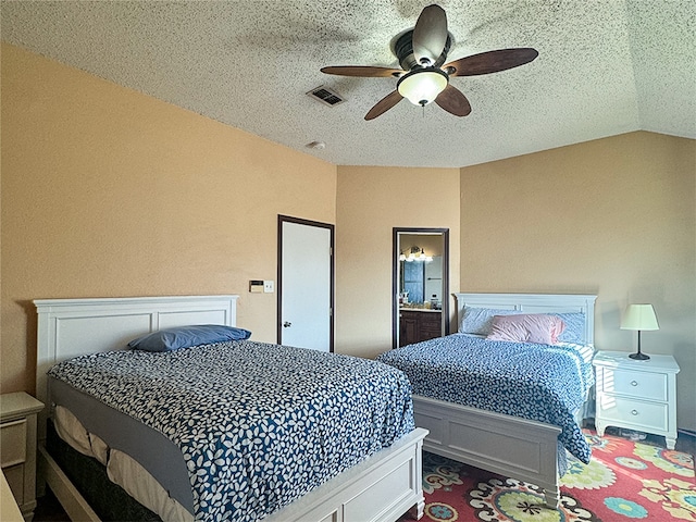 bedroom featuring ceiling fan, vaulted ceiling, and a textured ceiling