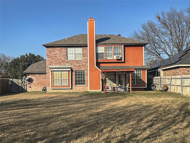 back of house featuring a lawn