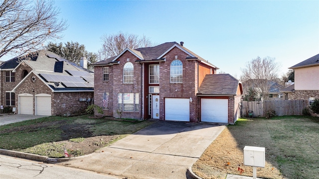 view of property featuring a front yard and solar panels