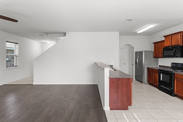 kitchen featuring black appliances, ceiling fan, and light tile patterned floors